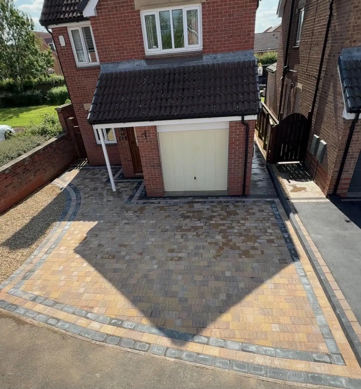 Block paving driveway in warm tones with contrasting borders and a curved edge
